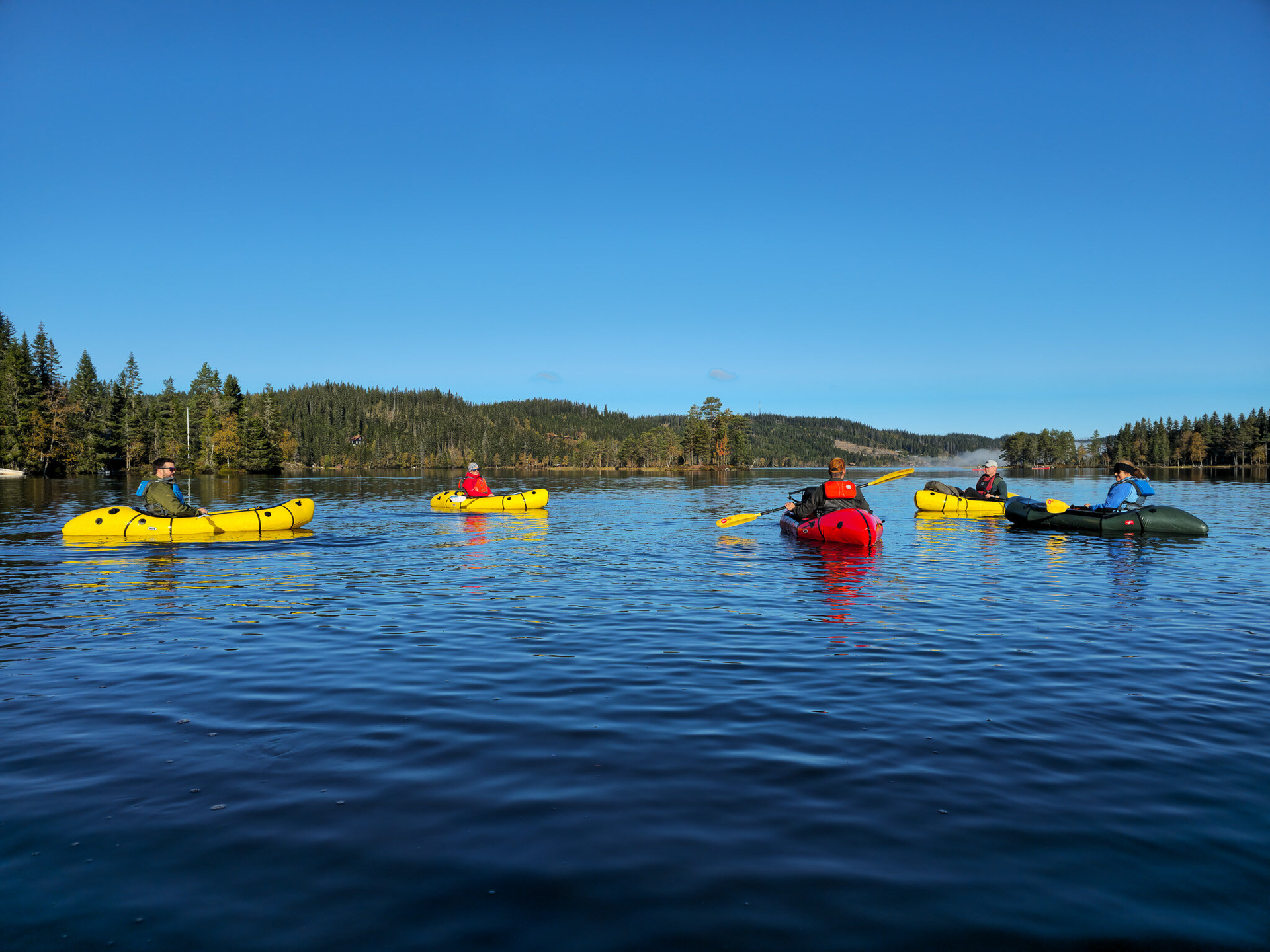 Peaceful packrafting on a quiet forest lake